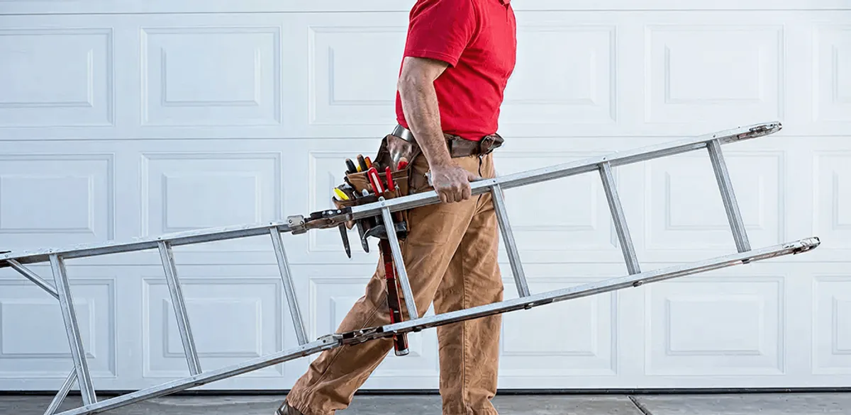 Garage door repair technician arriving with tools and ladder in Des Moines, IA